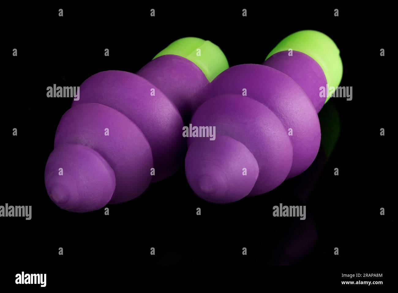 Close up of purple and green ear plugs Stock Photo