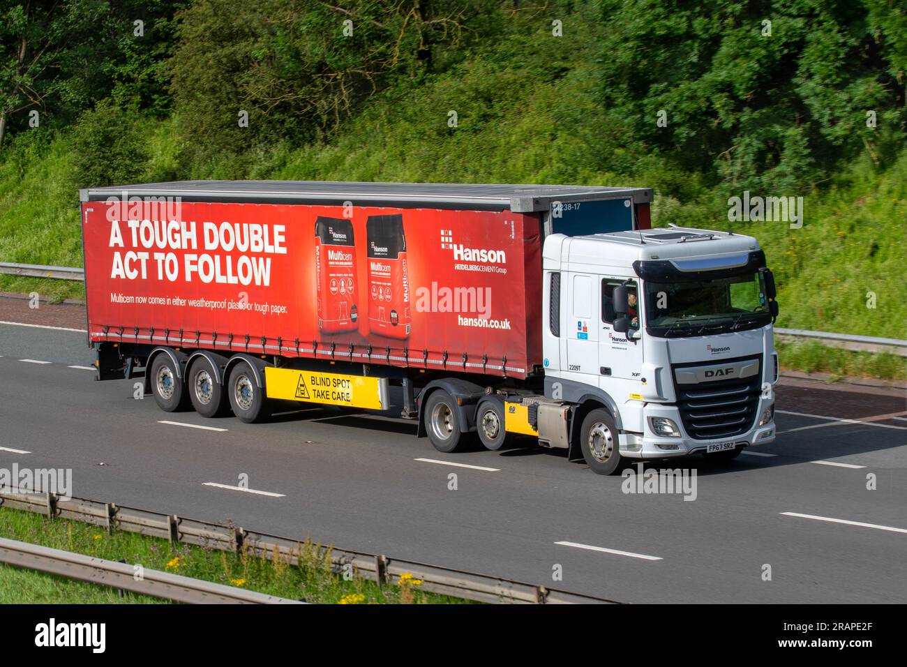 'Gringo' Driving Ashbrook HGV with Hanson Trailer 'A Tough Double Act to Follow' HeidelbergCement  a German multinational building materials provider DAF XF; travelling on the M6 motorway in Greater Manchester, UK Stock Photo