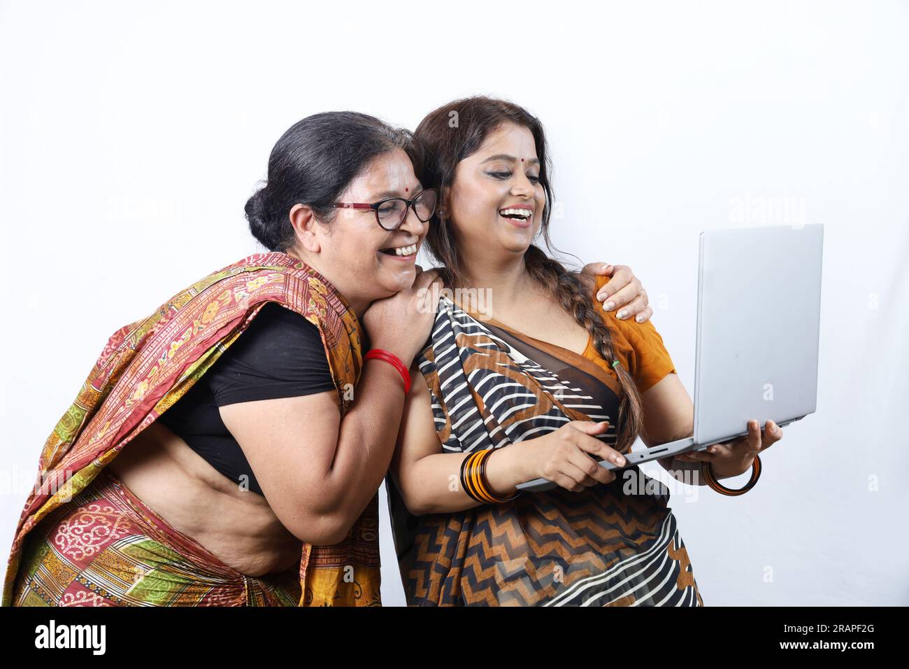 Rural Indian happy women holding laptop as digitalization concept. Internet reaching every village in India. Women empowerment. Rural education. Stock Photo