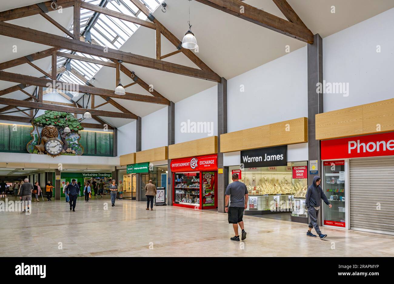 The Isaac Newton Shopping Centre in Grantham, Lincolnshire UK with the famous clock visible on the back wall, where a lion opens its eyes every hour and an apple falls Stock Photo