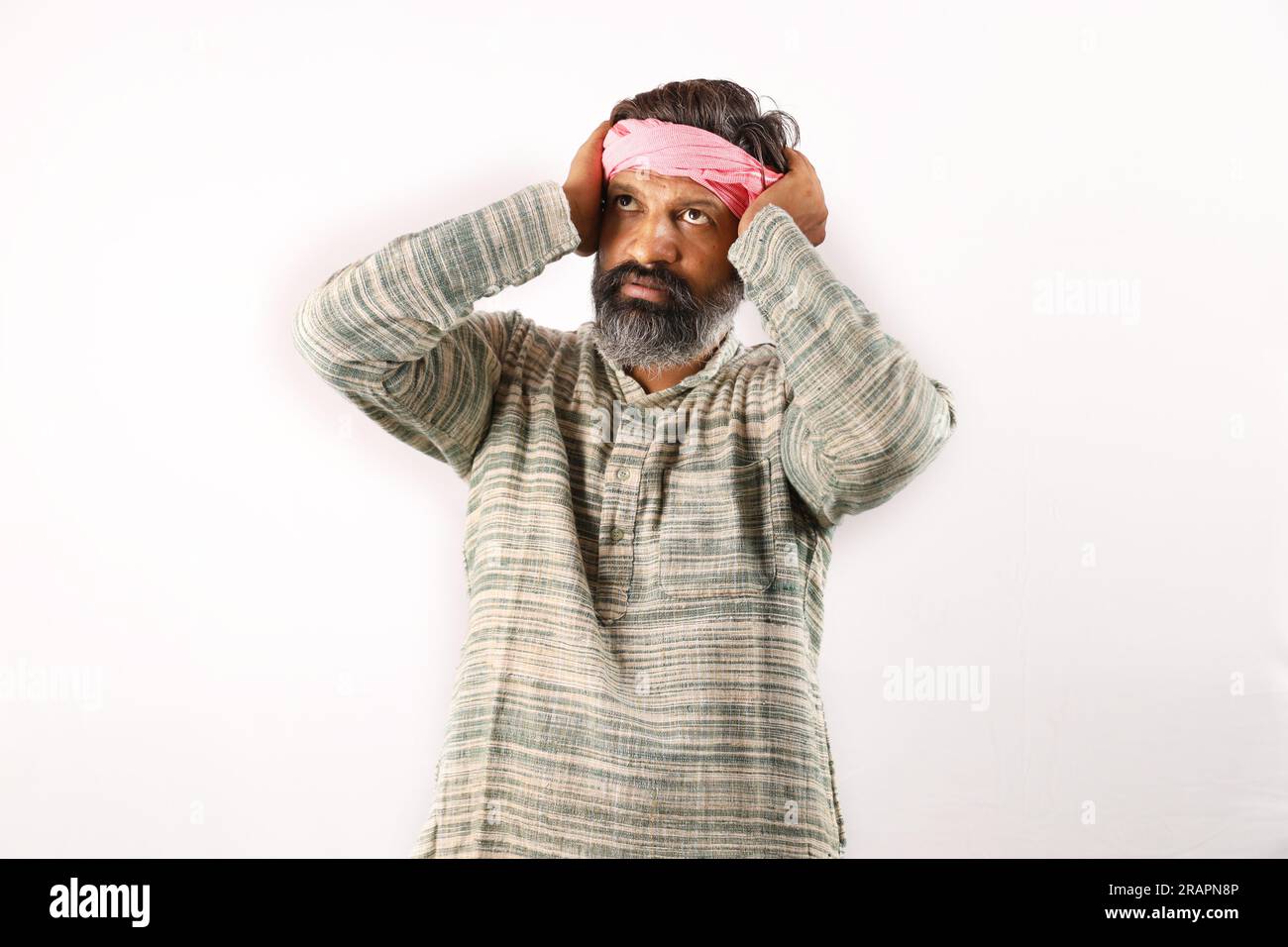 Portrait of Indian bearded man in rural India concept. Funky expressions white background. poor villager man. various expressions and moods of poverty Stock Photo