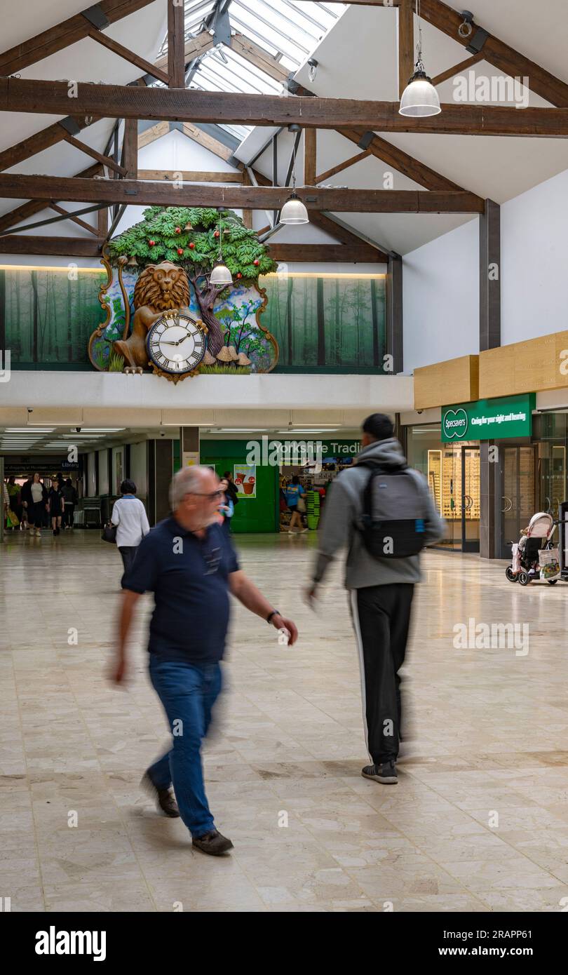 The Isaac Newton Shopping Centre in Grantham, Lincolnshire UK with the famous clock visible on the back wall, where a lion opens its eyes every hour and an apple falls Stock Photo