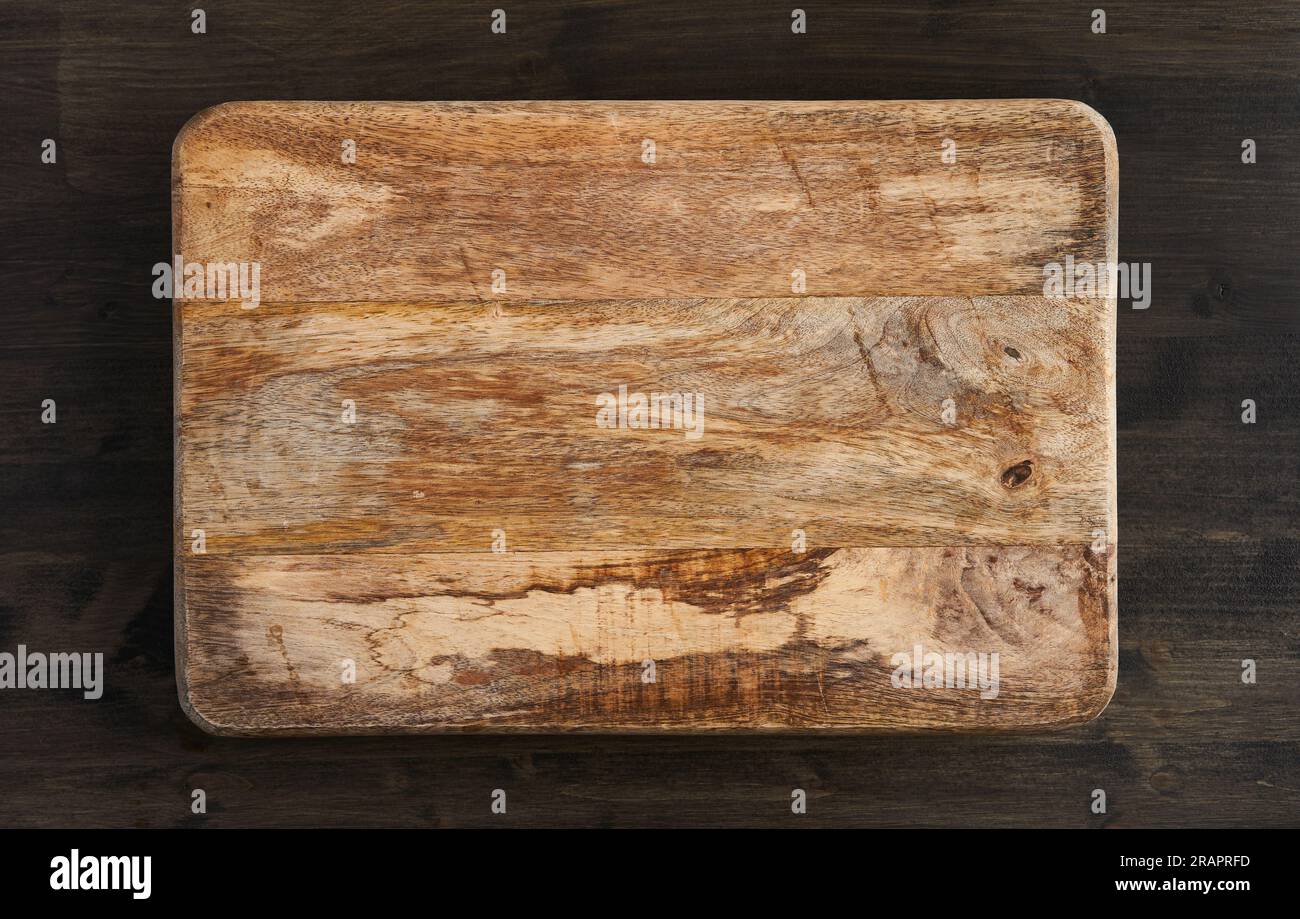 Rustic textured mango wood chopping board with copyspace for text, flat lay Stock Photo