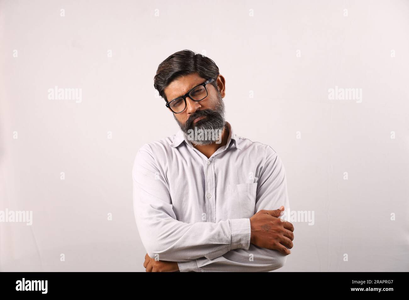 Portrait of an Indian bearded man wearing shirt. Funky expressions sad and downhearted full of sorrow and regretful. Anguish despair man displeased. Stock Photo