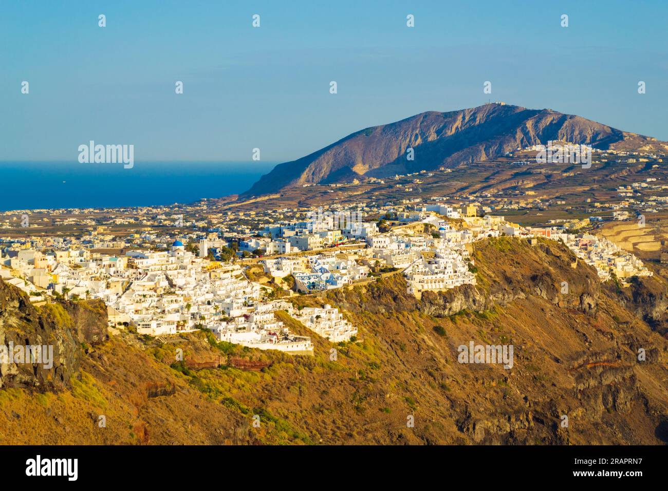 Scenic view of Santorini Caldera cliff face with traditional white housea,terraces of sleek bars, fine-dining restaurants, and upscale boutique hotels Stock Photo