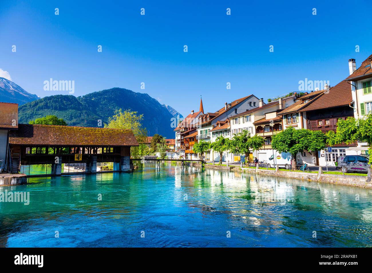 Grosse Staatsschleuse covered bridge, houses at the riverside of the Aare River, Unterseen, Switzerland Stock Photo