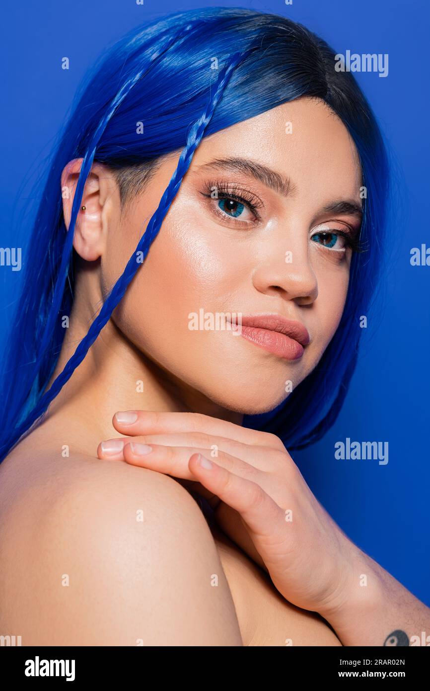 skin perfection, young woman with dyed hair posing on blue background, hair color, individualism, female model with makeup and trendy hairstyle, vibra Stock Photo