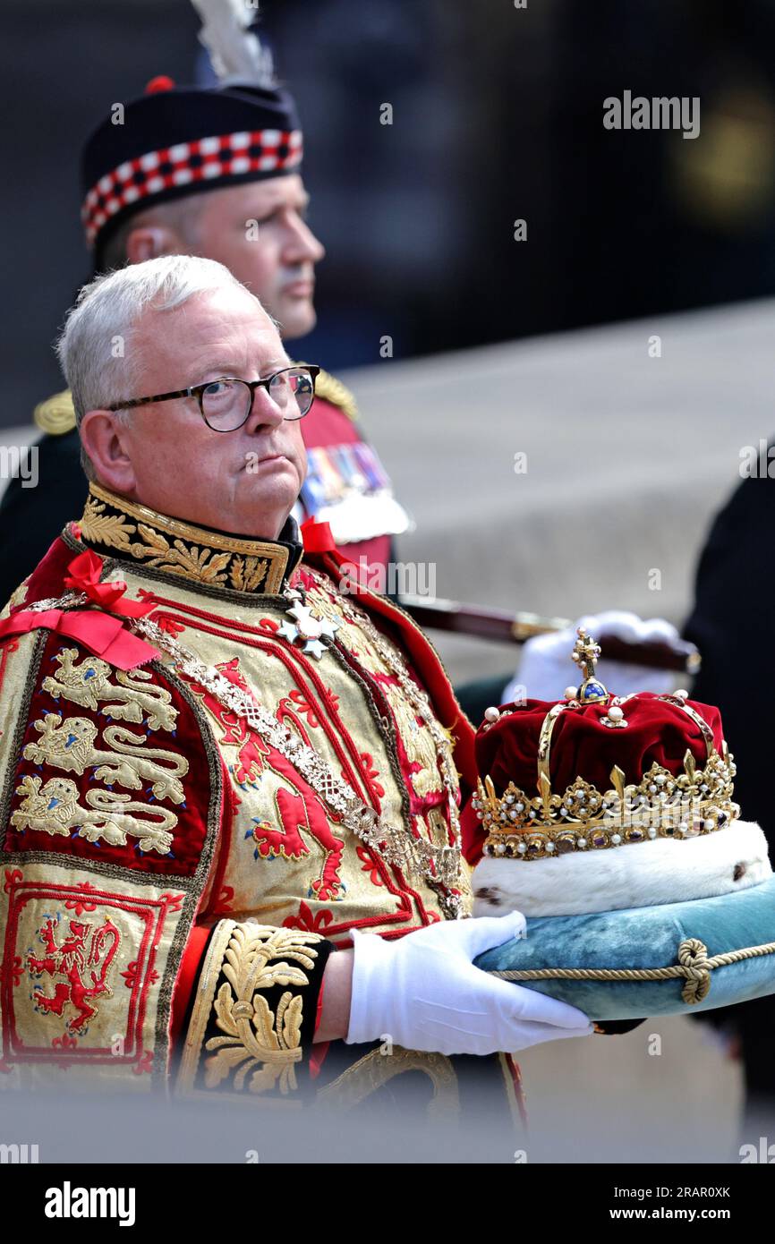 Lord Lyon King of Arms Joseph Morrow carrying the Crown, which forms