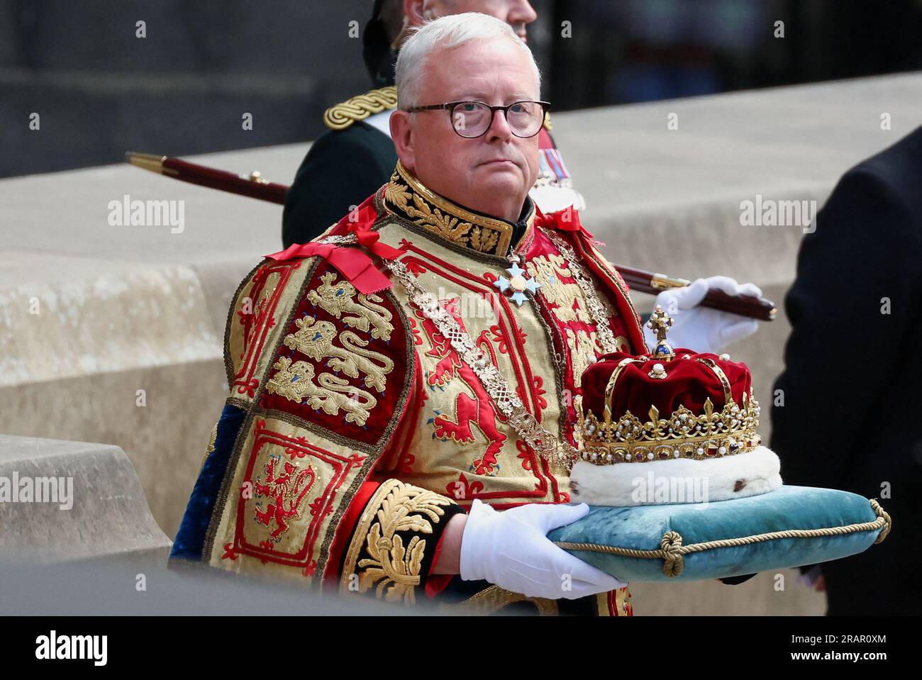 Lord Lyon King of Arms Joseph Morrow carrying the Crown, which forms