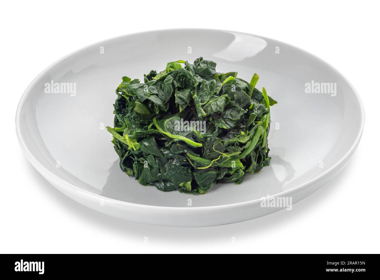 Spinach cooked in white dish isolated on white with clipping path
