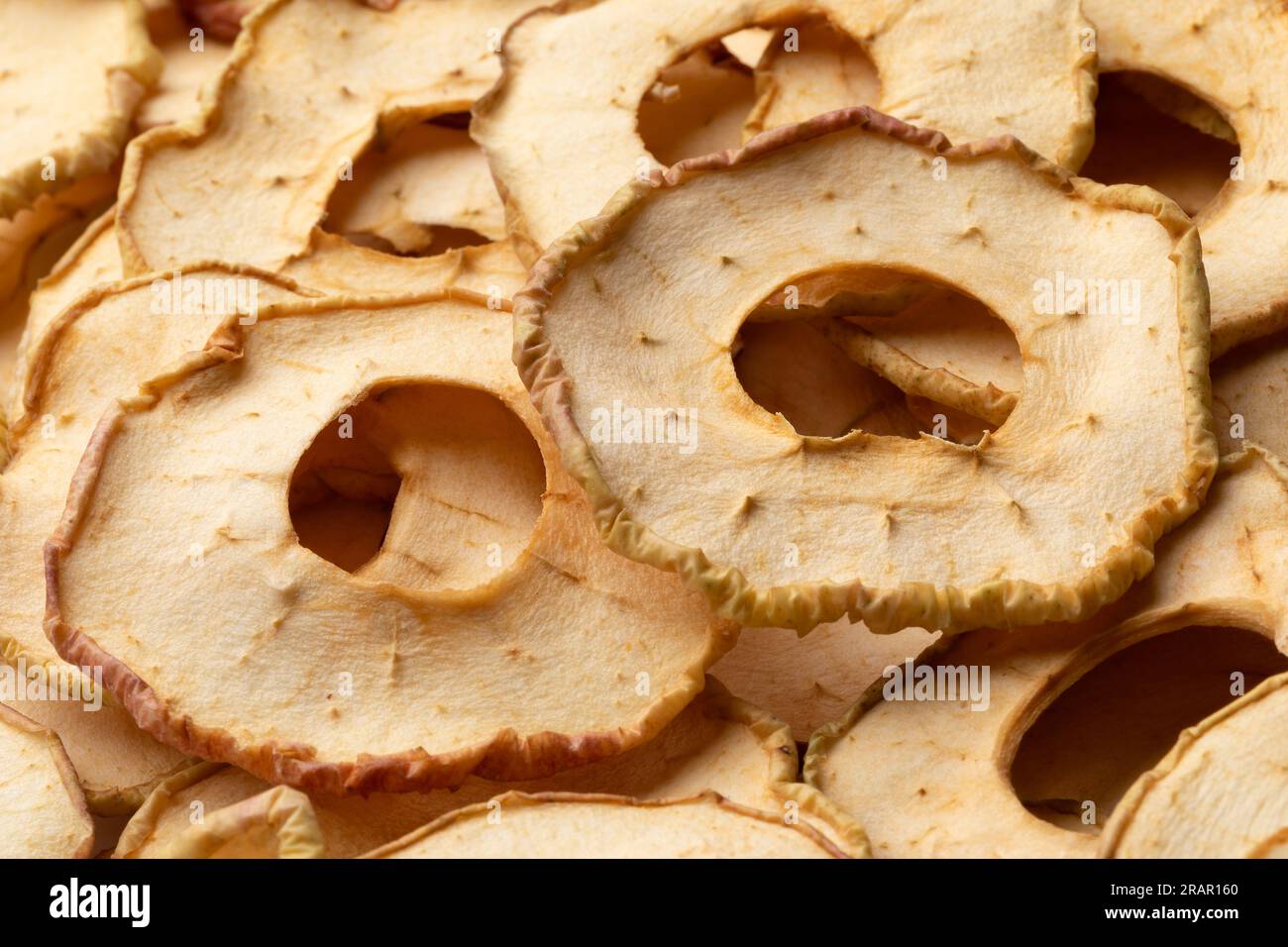 Dried apple chips full frame close up as background Stock Photo