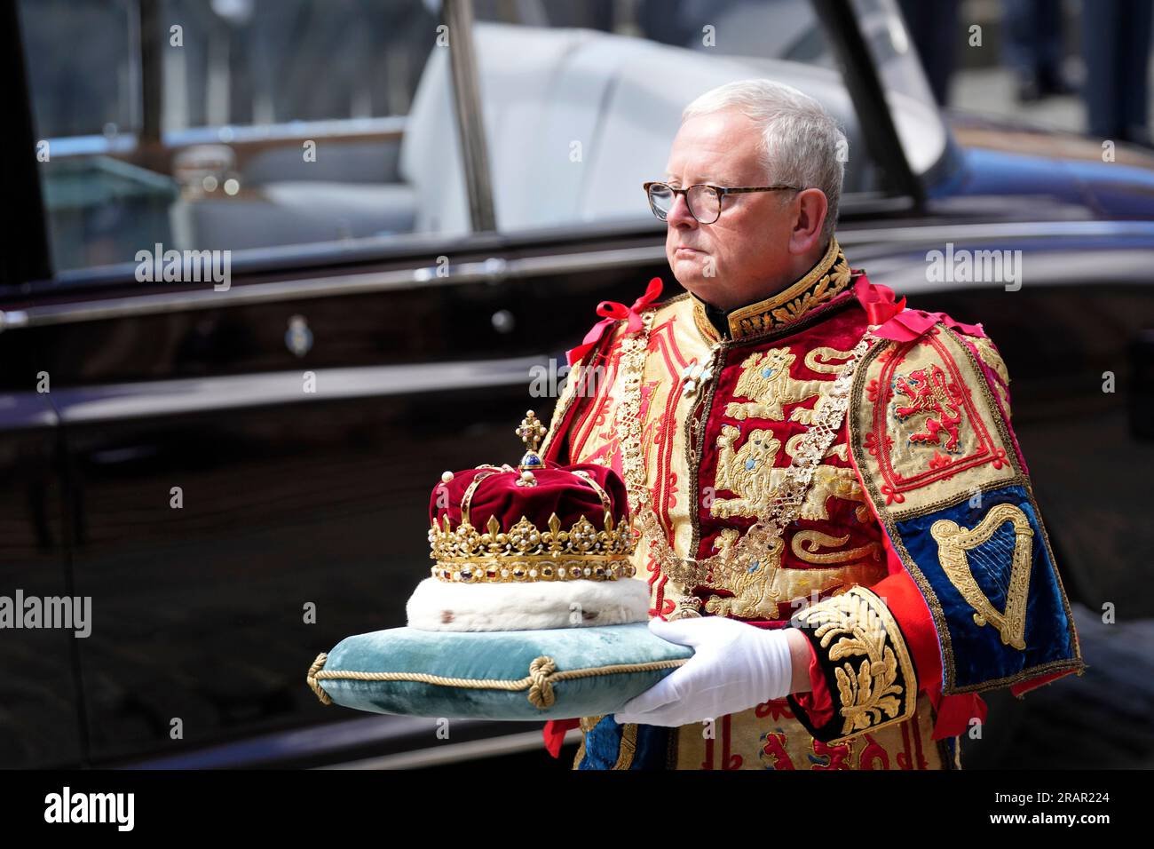 Lord Lyon King of Arms Joseph Morrow carries the Crown, which forms