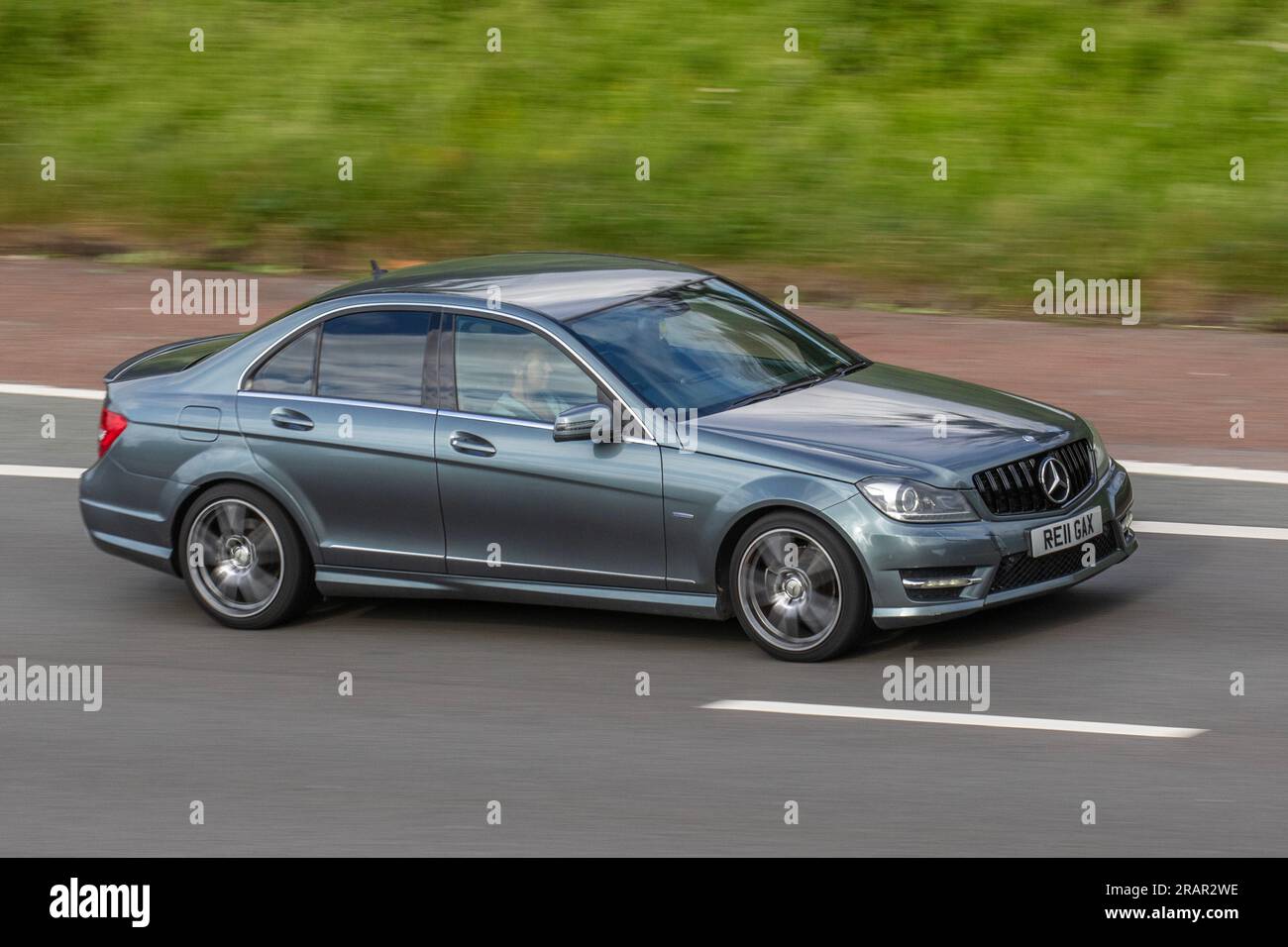 2011 Grey Mercedes-Benz C220 Sport CDI Blueeffi-C, A C220 Cdi Blueefficiency 7G-Tronic Auto Start/Stop saloon Car Diesel 2143 cc; travelling at speed on the M6 motorway in Greater Manchester, UK Stock Photo