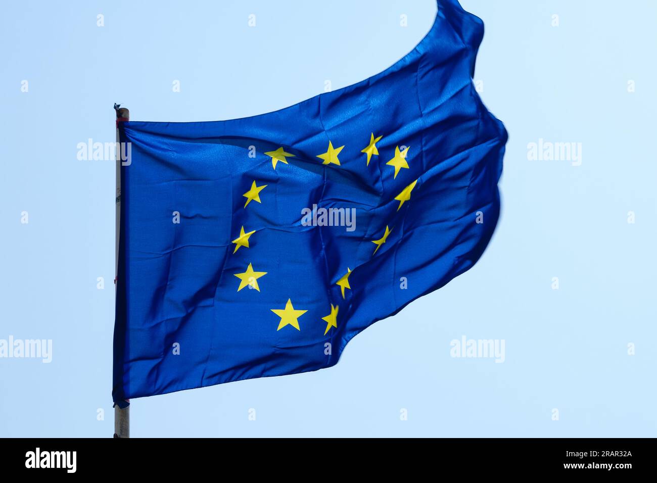 Shot close to the blue flag of the European community, the circle formed by yellow stars represents the component nations. Stock Photo