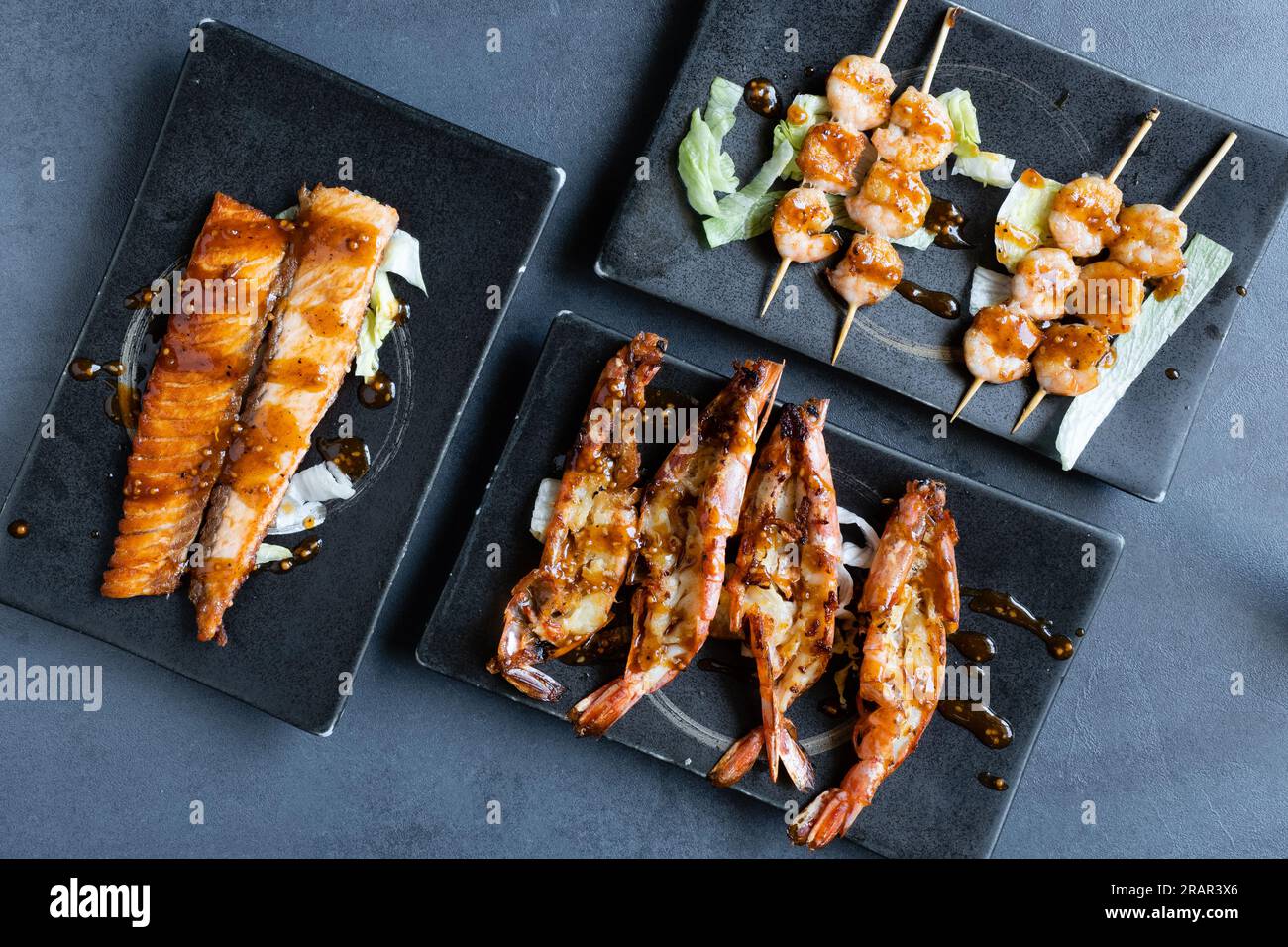 Sushi restaurant, top view of a mix of grilled Japanese dishes. Stock Photo