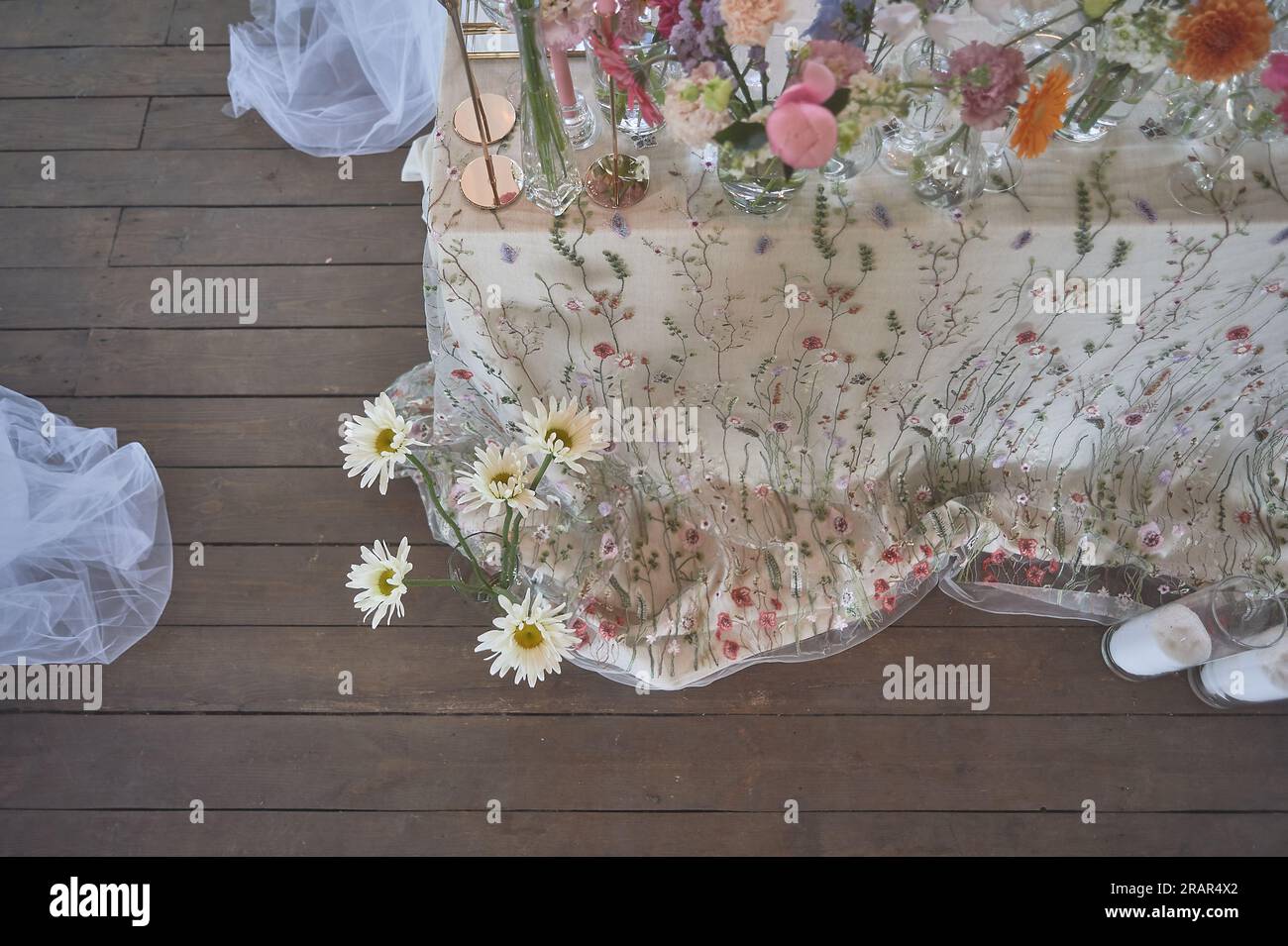 Floristics. Floral decoration of the wedding in pastel colors. Many flowers in different vases and vessels Stock Photo