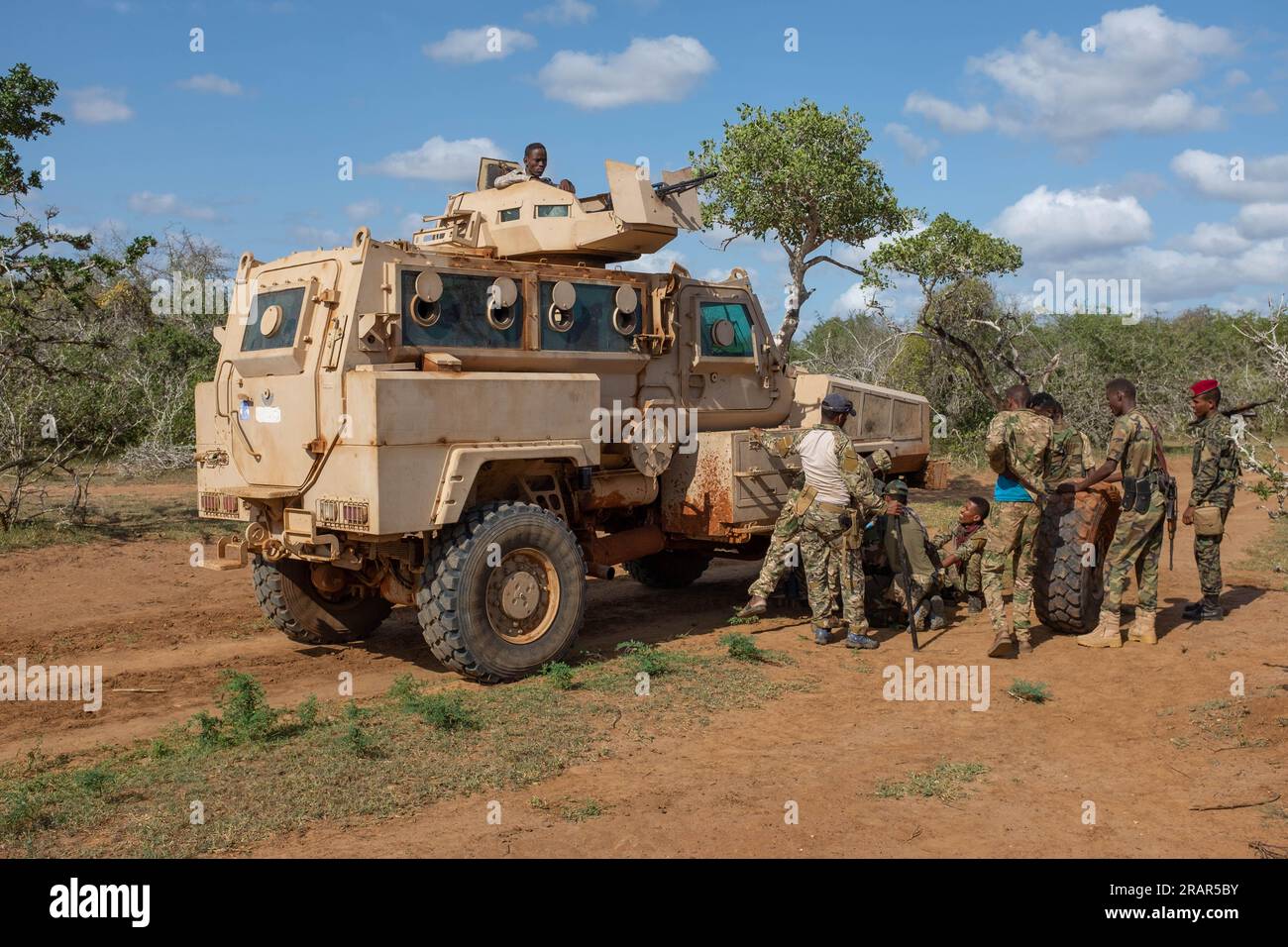 Somali soldiers change out a tyre on their Mamba APC in the bush, Southern Somalia Stock Photo