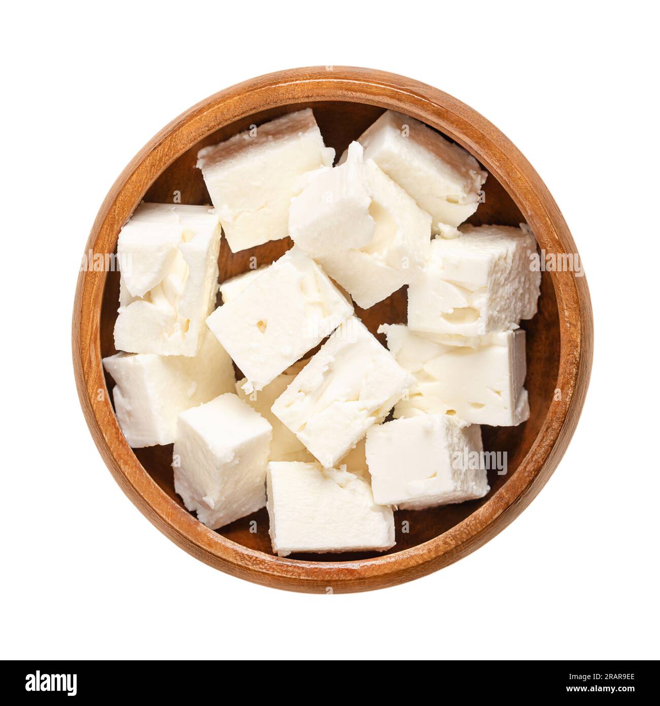 Greek feta cubes, brined cheese cut in block shape, in a wooden bowl