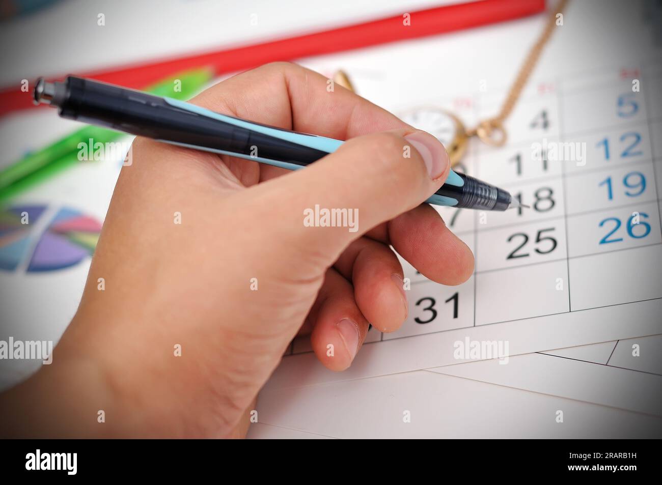 hand of businessman puts a mark on the calendar Stock Photo Alamy