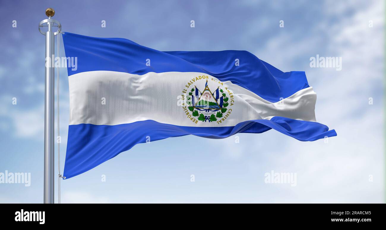 El Salvador national flag waving on a clear day. Three horizontal bands of blue and white with the coat of arms in the center. Central America country Stock Photo