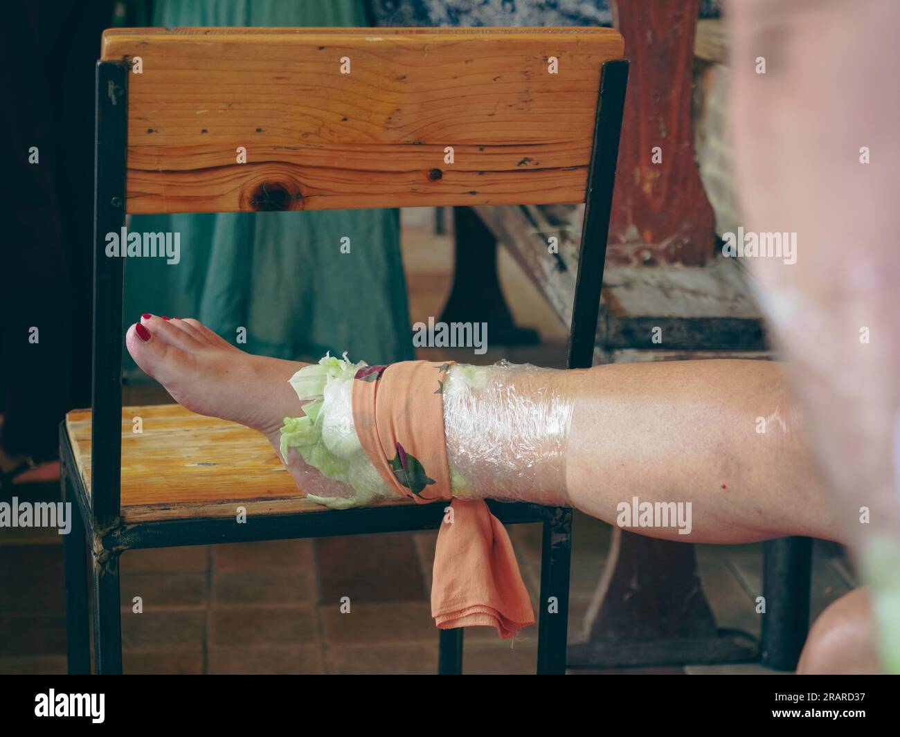 woman feet wrapped in cabbage leaves compress for anti inflammatory