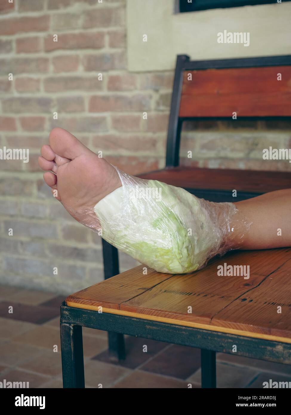 woman feet wrapped in cabbage leaves compress for anti inflammatory