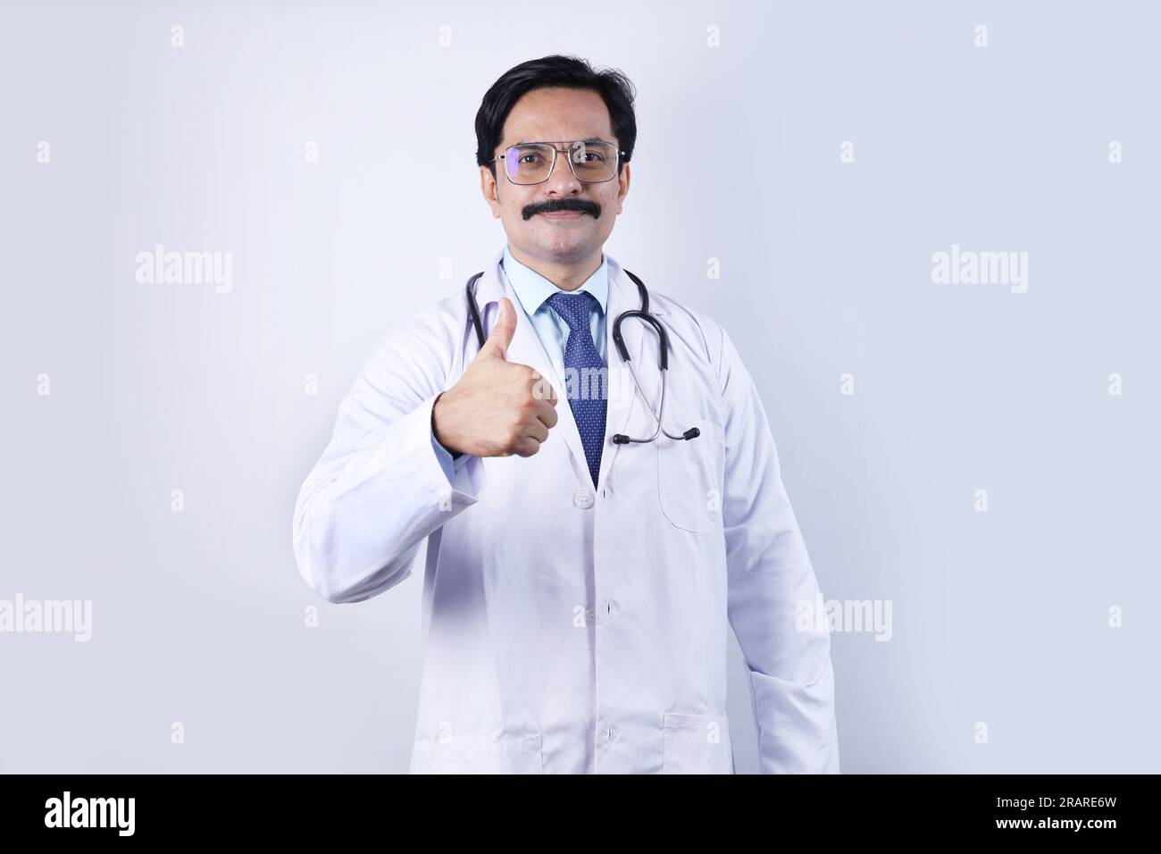Portrait of happy Indian doctor in uniform wearing stethoscope and