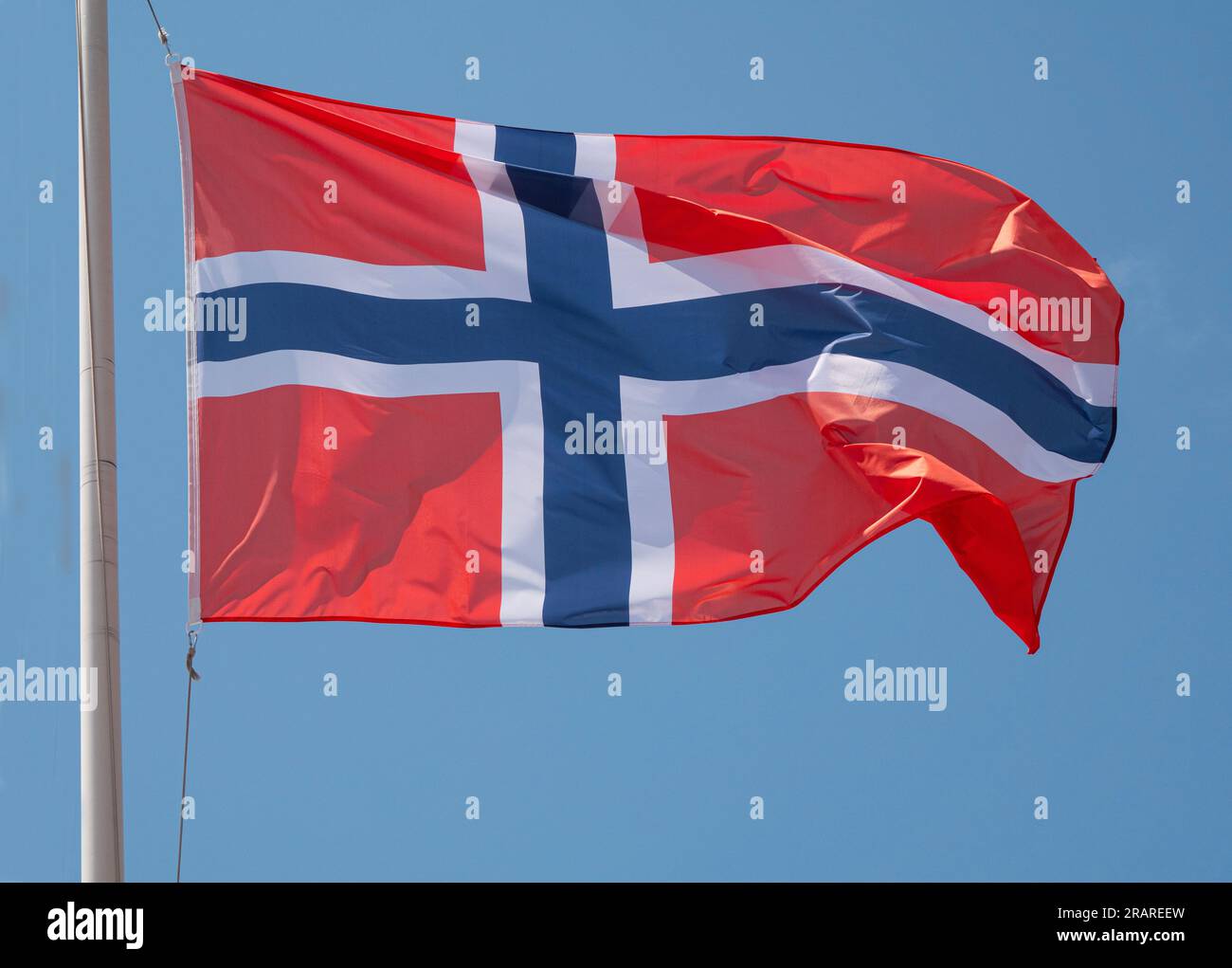 Norway the Norwegian national flag waving in the wind on a flagpole ...