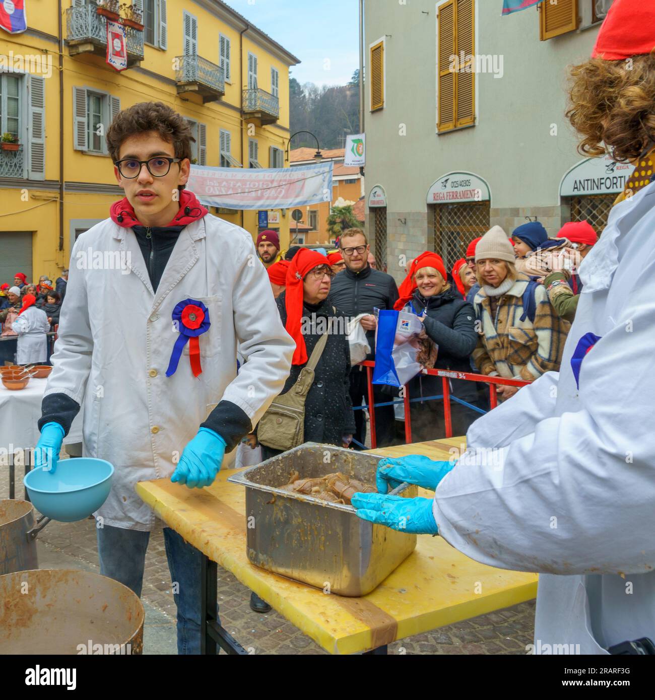 Ivrea, Italy - February 19, 2023: People preparing bean soup and other food, a tradition that is part of the historical carnival of Ivrea, Piedmont, N Stock Photo