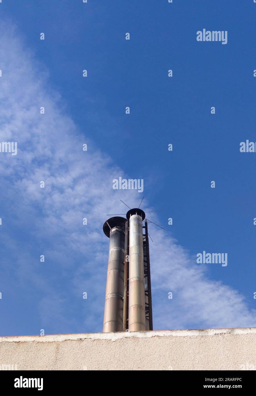 Industrial chimney protected with lightning rod. Blue sky background