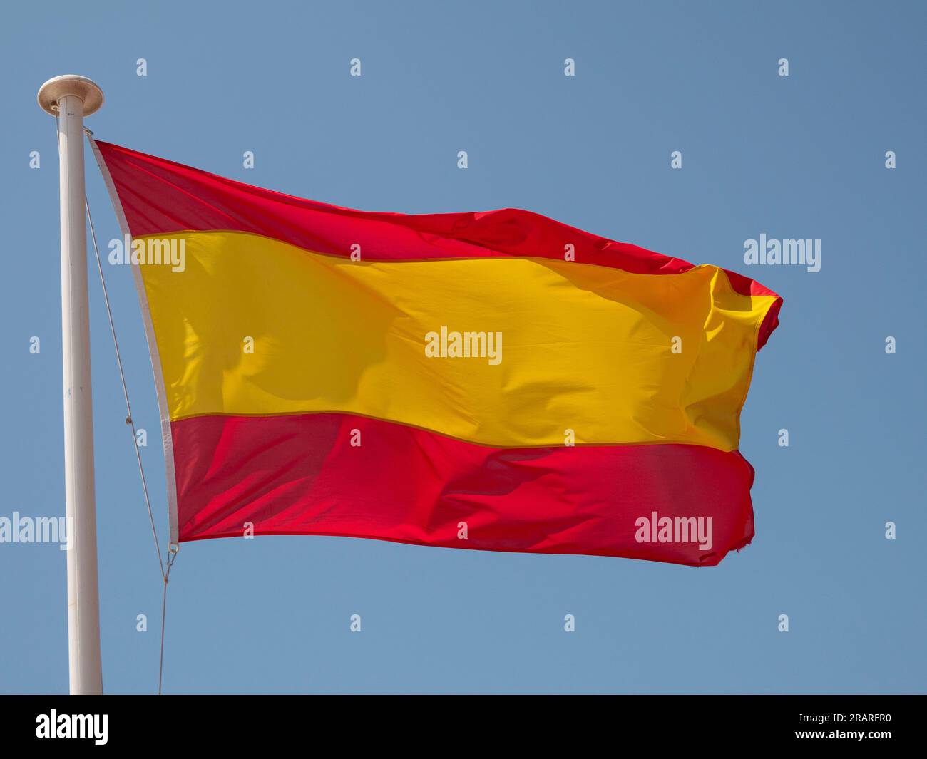 Spain the Spanish national flag waving in the wind on a flagpole with