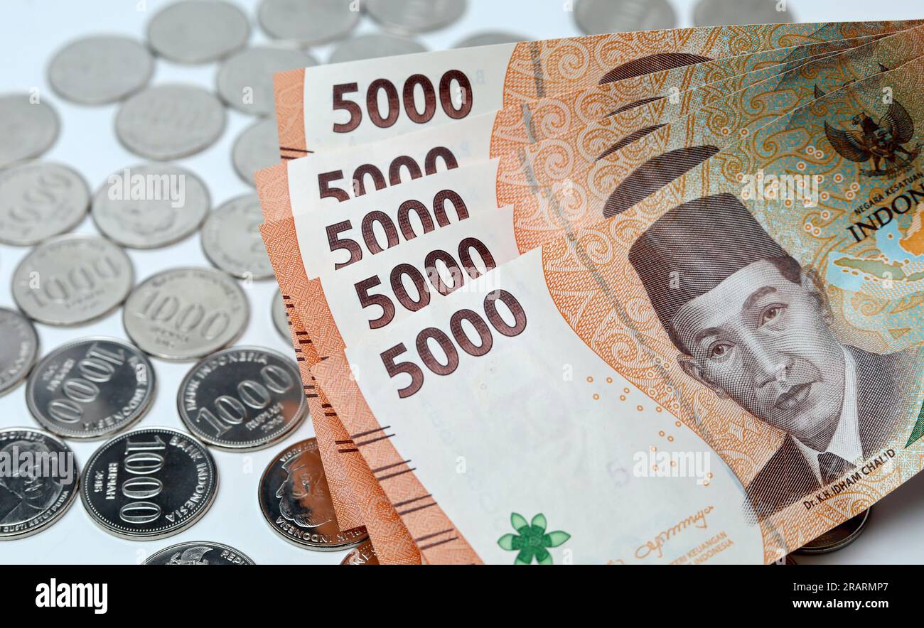 Coins and paper money with white background. Indonesian coin and paper currency Stock Photo