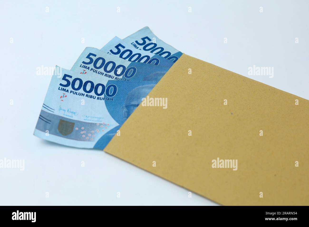 money in brown envelope isolated on the white background. Indonesian paper money currency Stock Photo