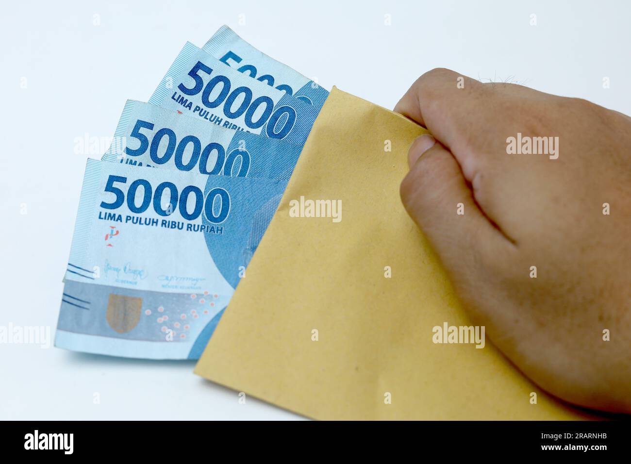 money in brown envelope isolated on the white background. Indonesian paper money currency Stock