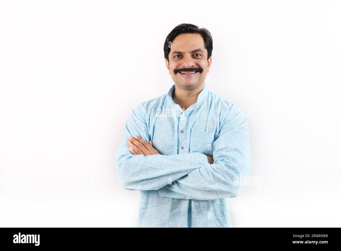 Happy Indian farmer in rural India concept. Standing in the white background, the passionate farmer full of enthusiasm is happy and ready to achieve. Stock Photo