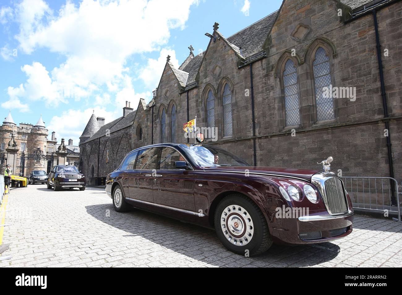 King Charles III and Queen Camilla are driven in a car from