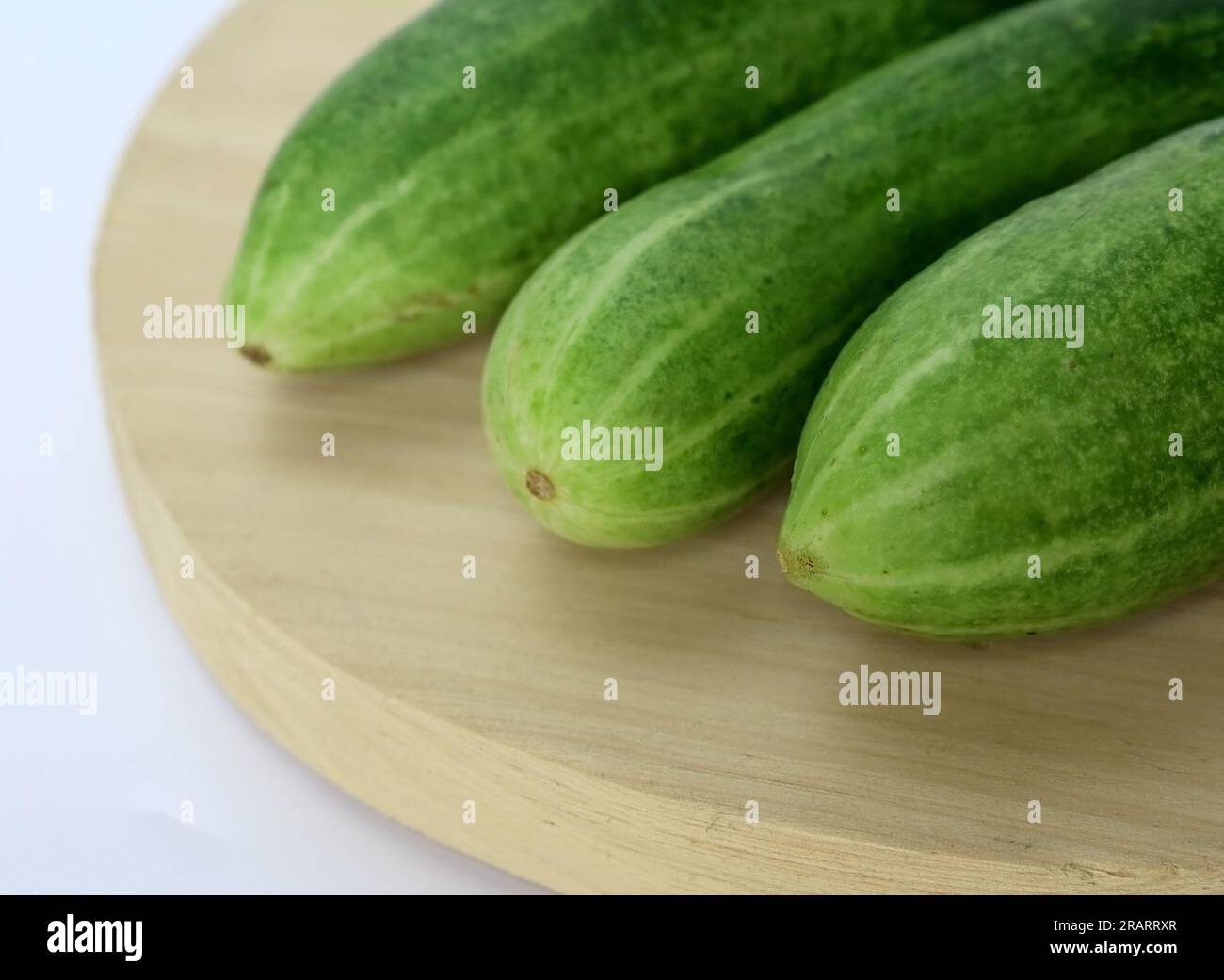 https://c8.alamy.com/comp/2RARRXR/fresh-green-and-healthy-cucumbers-on-wooden-board-2RARRXR.jpg