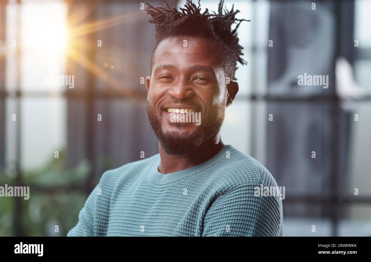 Thoughtful young black man looking straight ahead Stock Photo