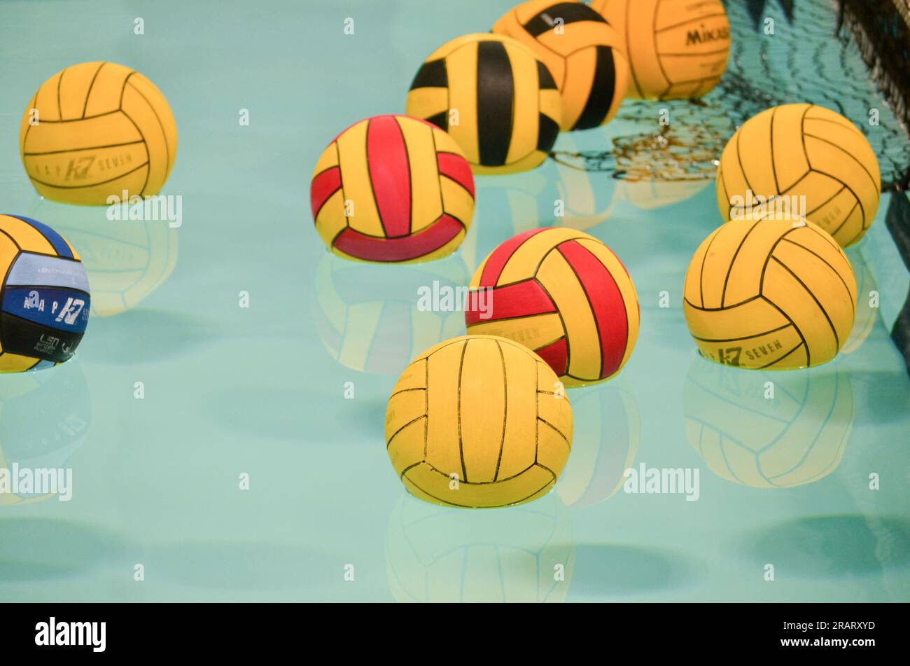 water polo balls floating in a swimming pool Stock Photo