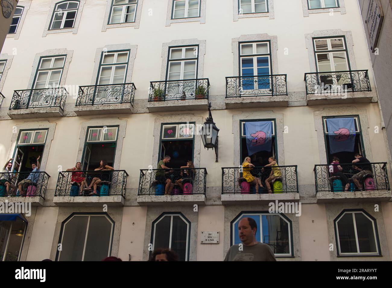 Lisbon typical building with verandas and people having drinks in a bar,downtown,near Chiado. Stock Photo