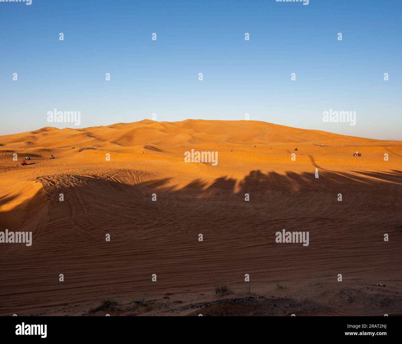 Tourists in Dubai desert on a sunny day in UAE Stock Photo