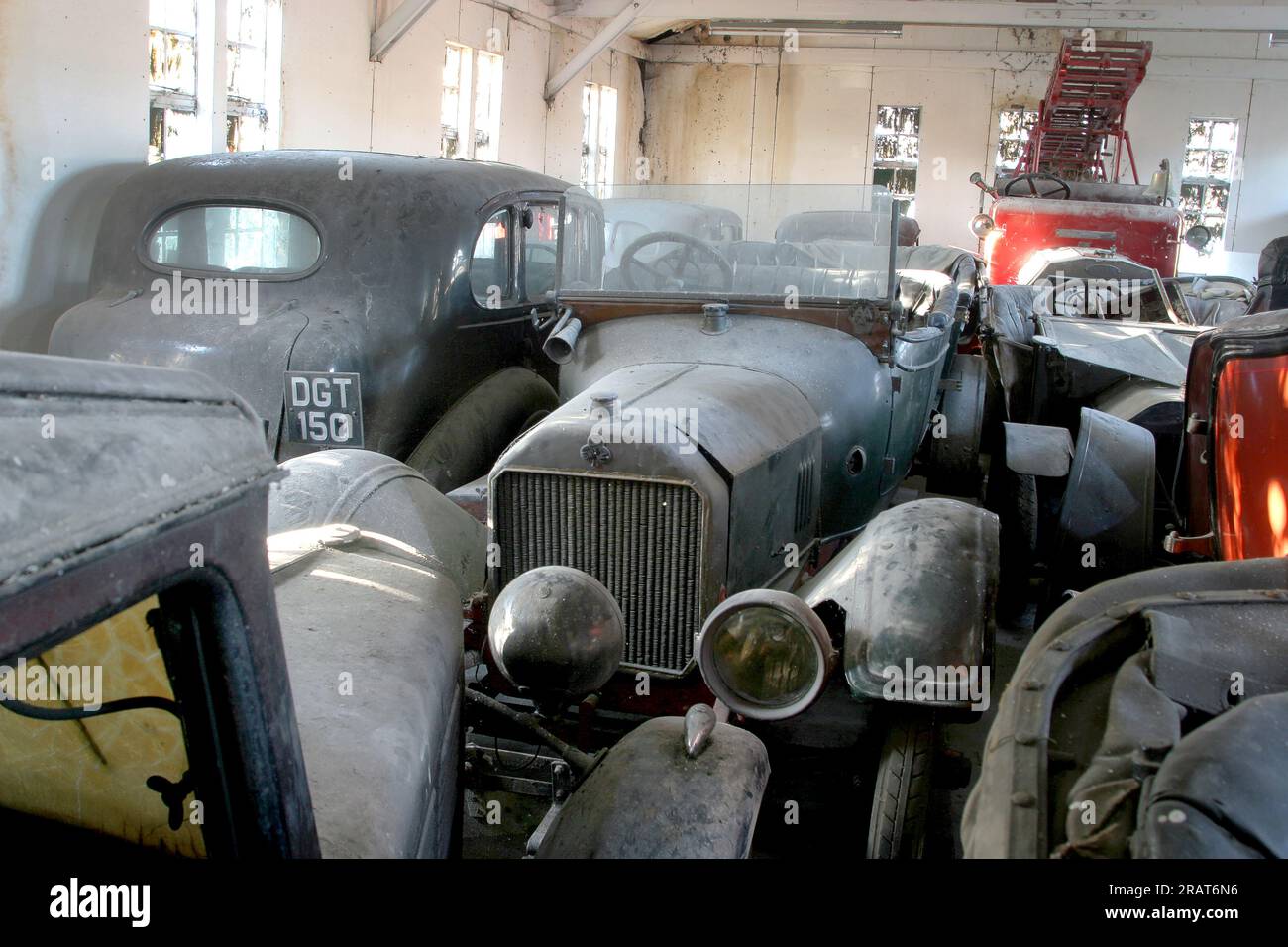 Dusty vintage cars are crammed into an old barn Stock Photo Alamy