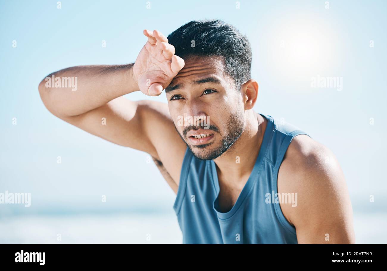 Fitness, sweating and man breathing at the beach after training