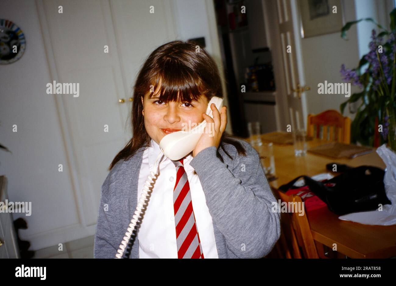 Young Girl Aged 9 Speaking on Landline Telephone Surrey England Stock Photo