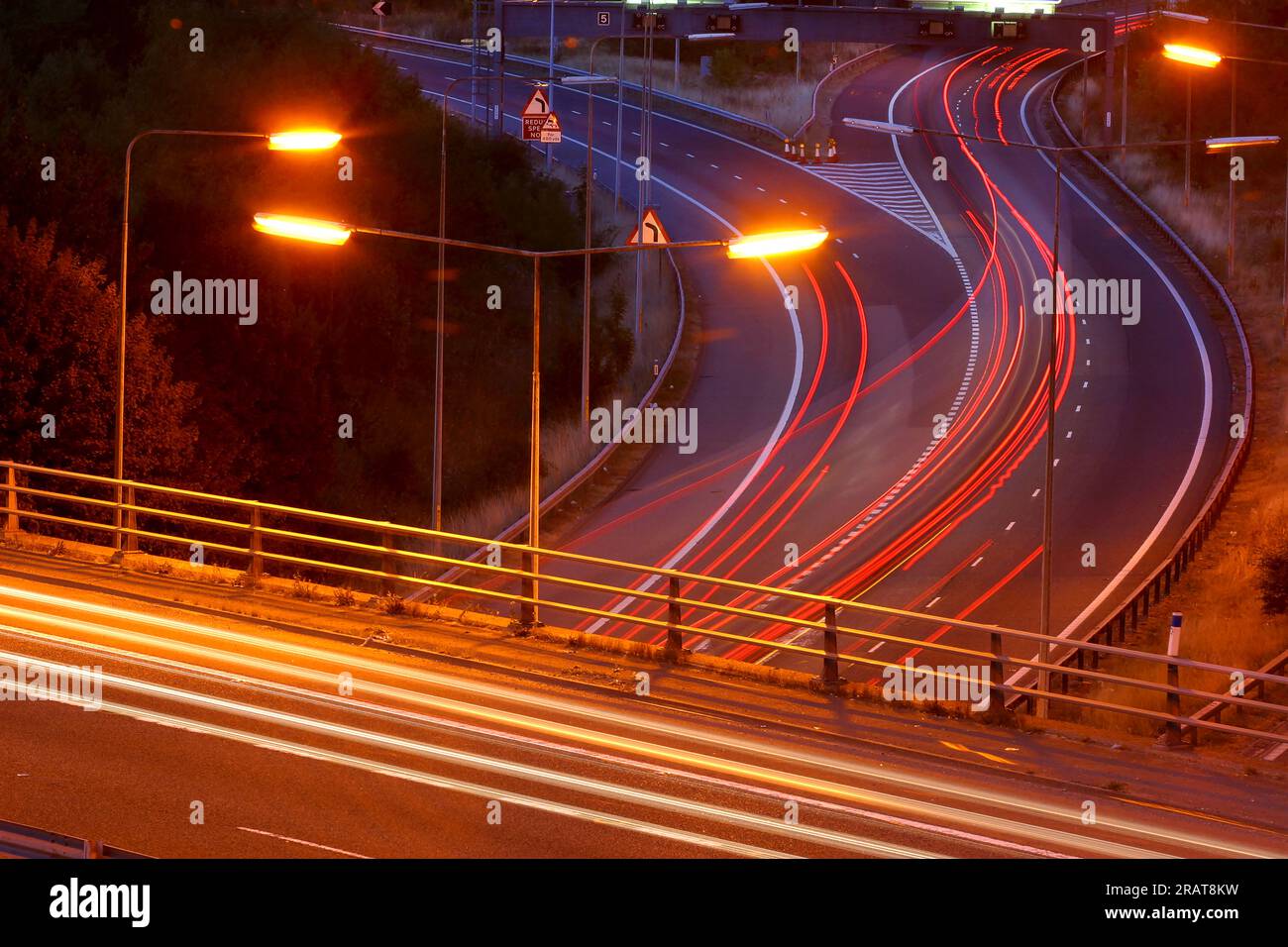 Tail lights blur under a highway bridge at night Stock Photo - Alamy