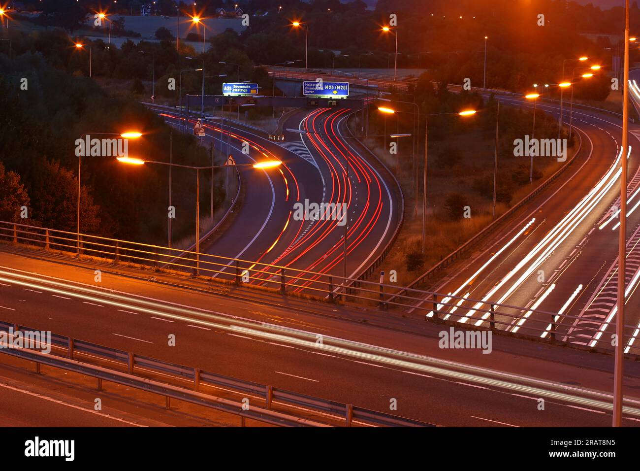 Car lights blur at night under a highway bridge Stock Photo - Alamy