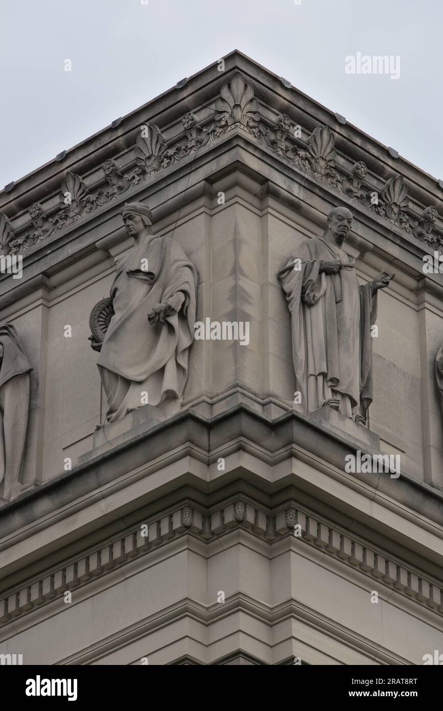 Multiple statues of historical and religious figures on the facade of