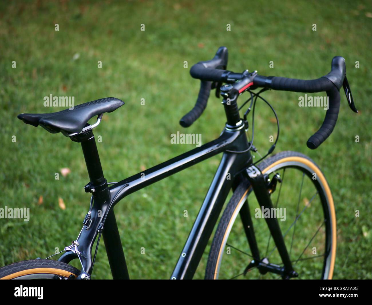 black carbon bicycle in field of grass (road bike with drop handlebars