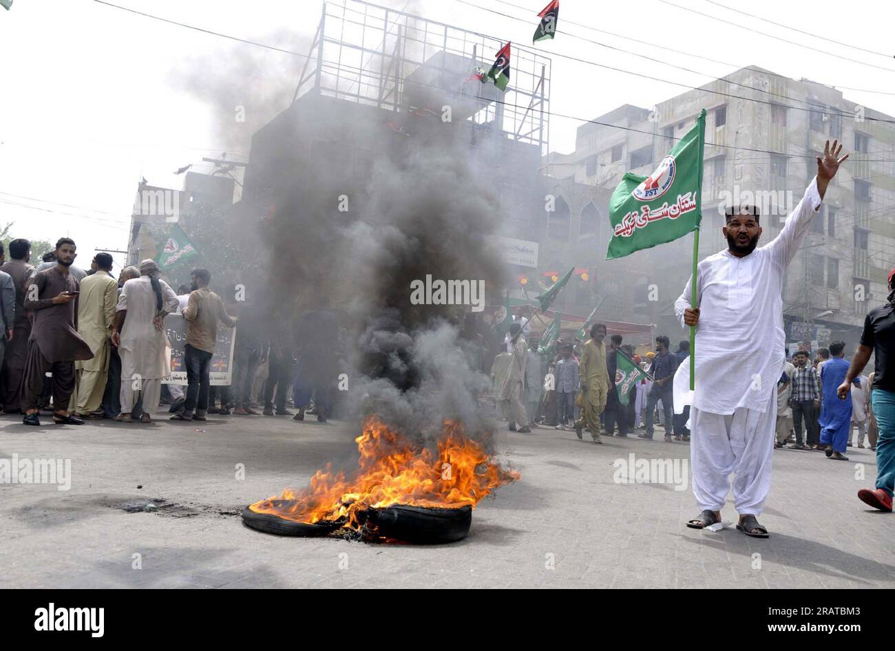 Activists of Sunni Tehreek (PST) are burn tires as they are holding protest demonstration against desecration of Holy Quran in Sweden, at Hyder Chowk in Hyderabad on Wednesday, July 5, 2023. Stock Photo