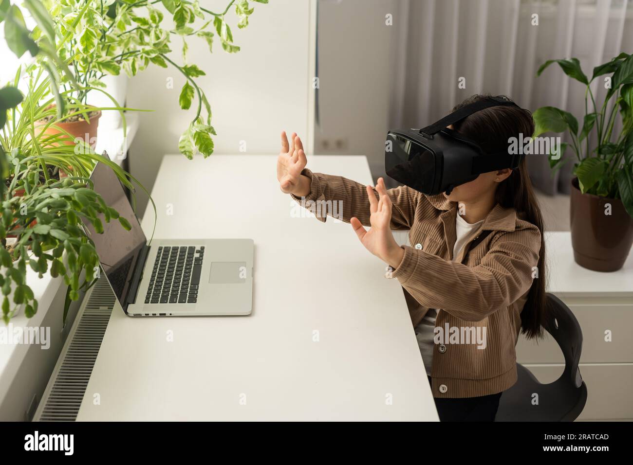 Virtual classes. Driving lessons. Science Class. VR technology. schoolgirl using virtual reality helmet. Virtual reality headset. Teenager student Stock Photo